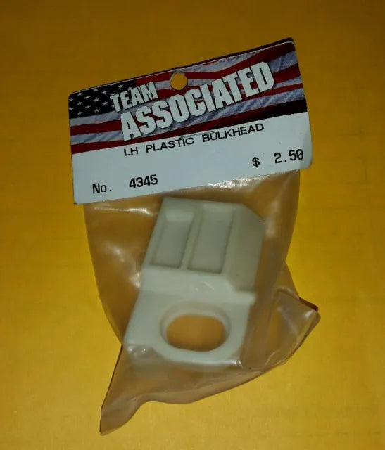 BRAND NEW Vintage TEAM ASSOCIATED #4345 RARE White LH PLASTIC BULKHEAD Left 12L